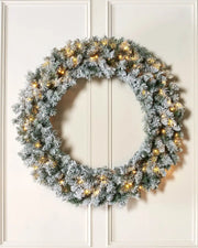 Full 1 m pre-lit snow-flocked majestic wreath displayed on a lifestyle wall