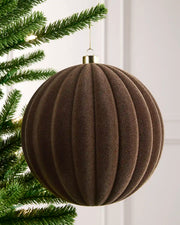 20 cm Mocha oversized velvet Ribbed bauble hanging from a Christmas tree with a gold cap.
