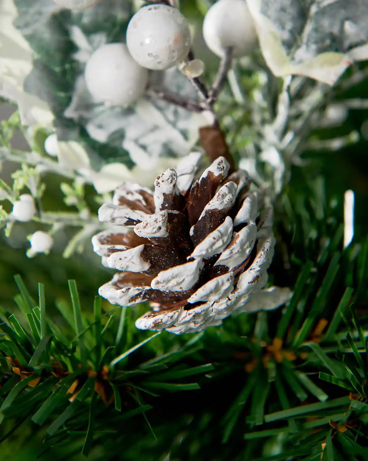 Close-up of the frosted pinecone detail on the 20 cm artificial berries pick