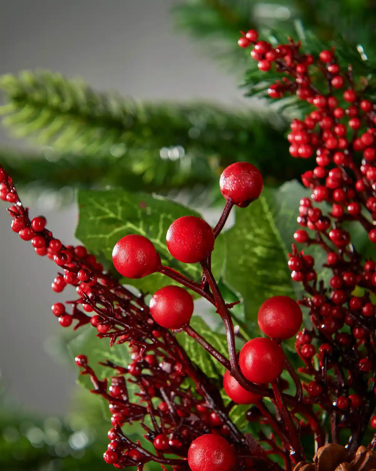 Detail of the glossy red berries and holly leaves on the 20 cm artificial tree pick