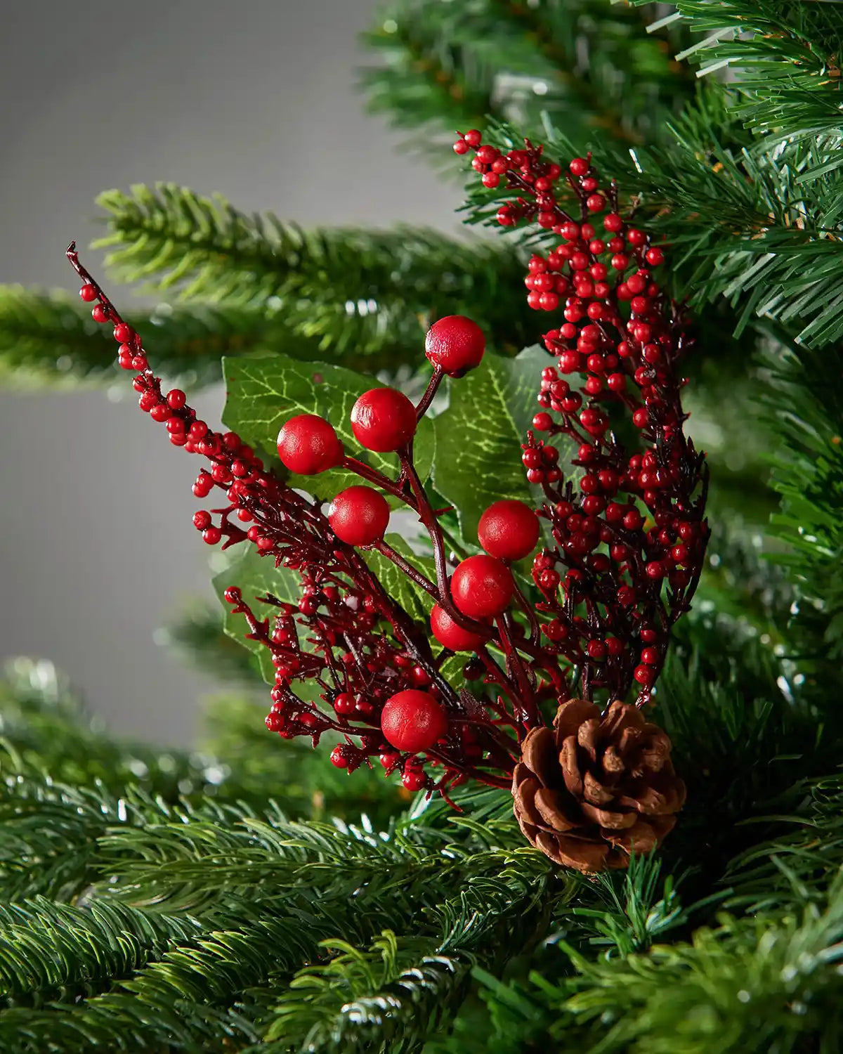 20 cm red artificial berries and pinecones tree pick styled in a Christmas tree