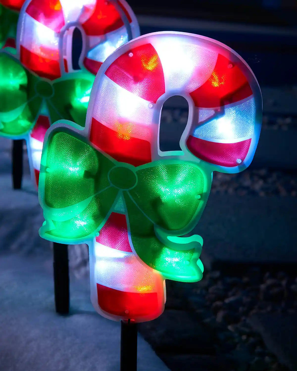 Close-up of a 24 cm candy cane pathway light with red, white and green illuminated details