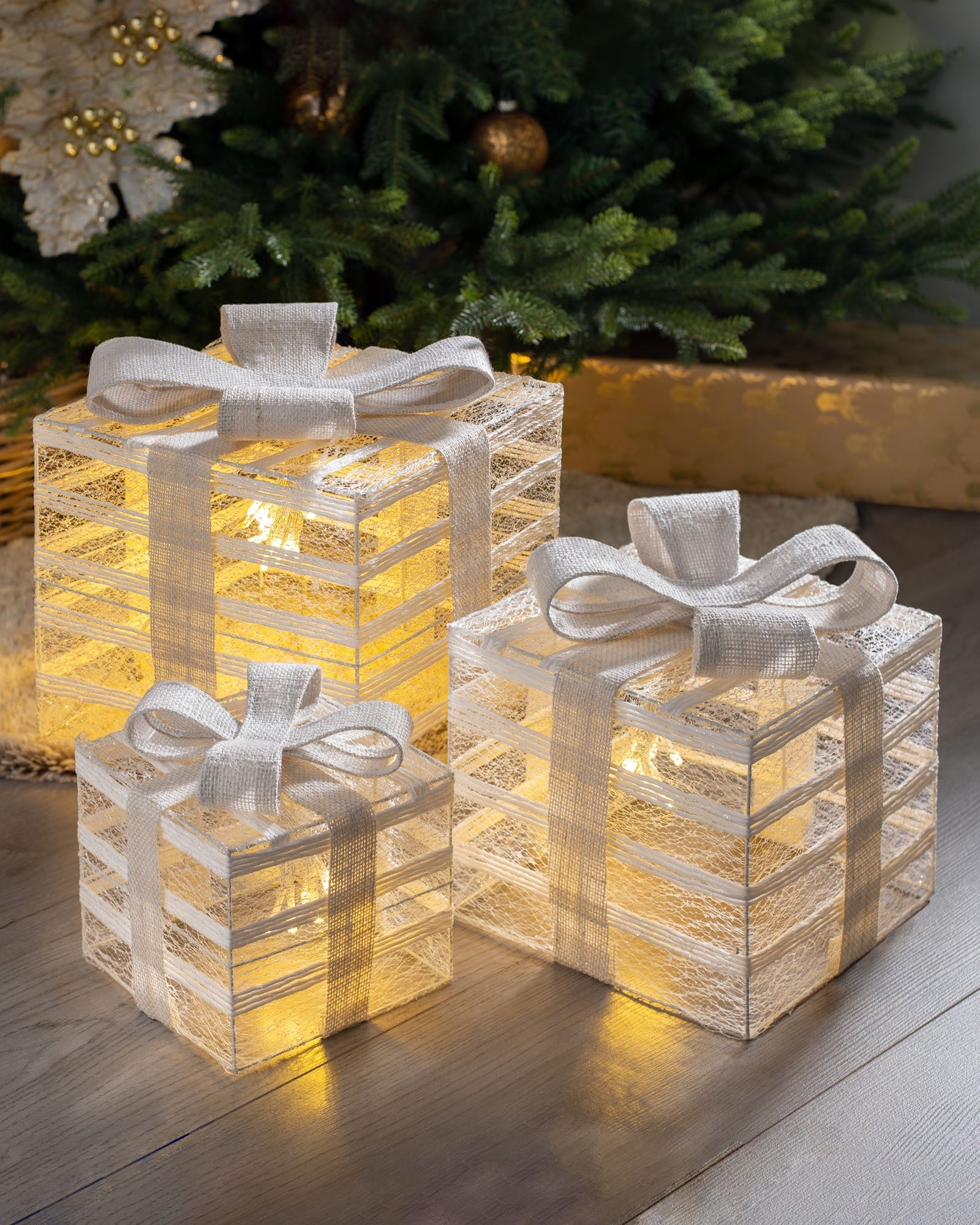 Set of three pre-lit Christmas gift boxes with warm white LEDs displayed under a tree