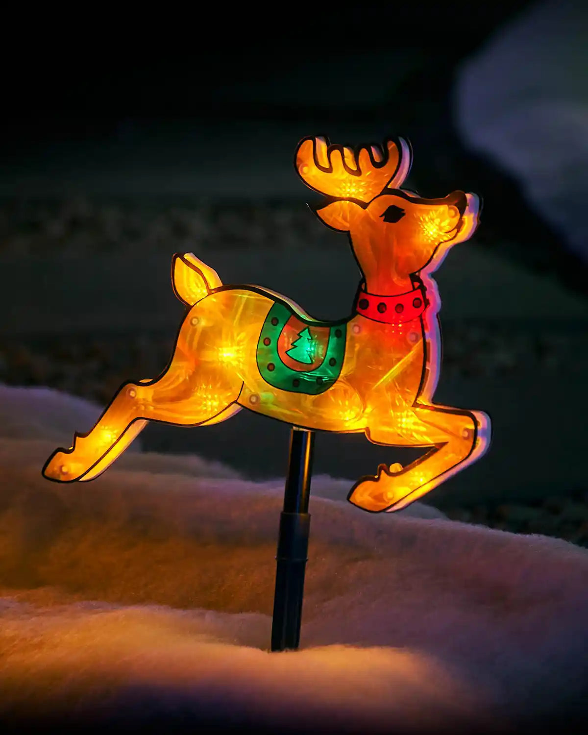 Close-up of one 26cm illuminated reindeer stake light with coloured saddle and black ground stake