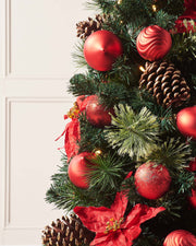 4-foot pre-lit potted Christmas tree with 140 PVC tips, warm white LED lights, red and silver baubles, pinecones, and berries, set against a white background.