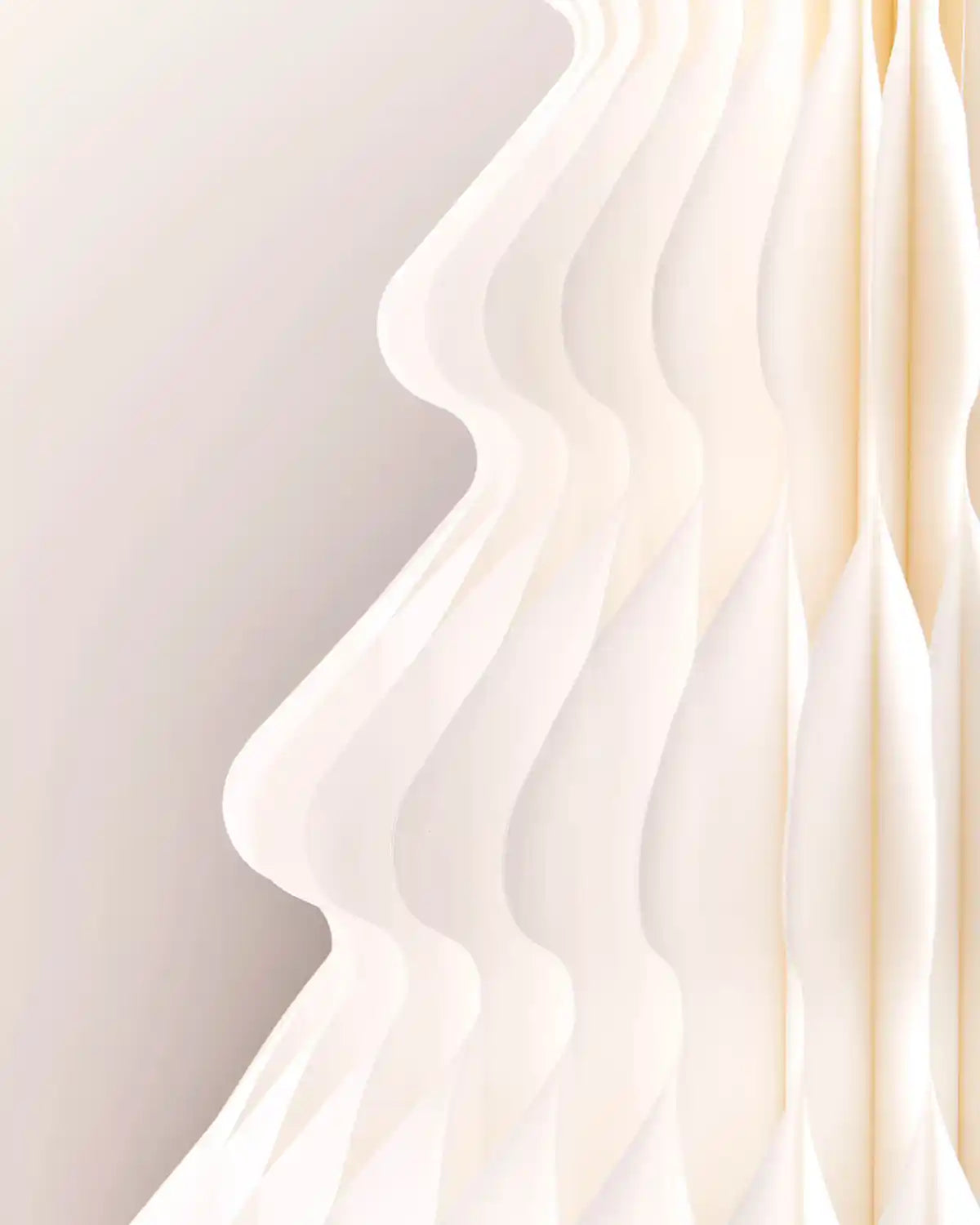 Close-up of the off-white honeycomb paper folds on a 2ft Christmas tree decoration.