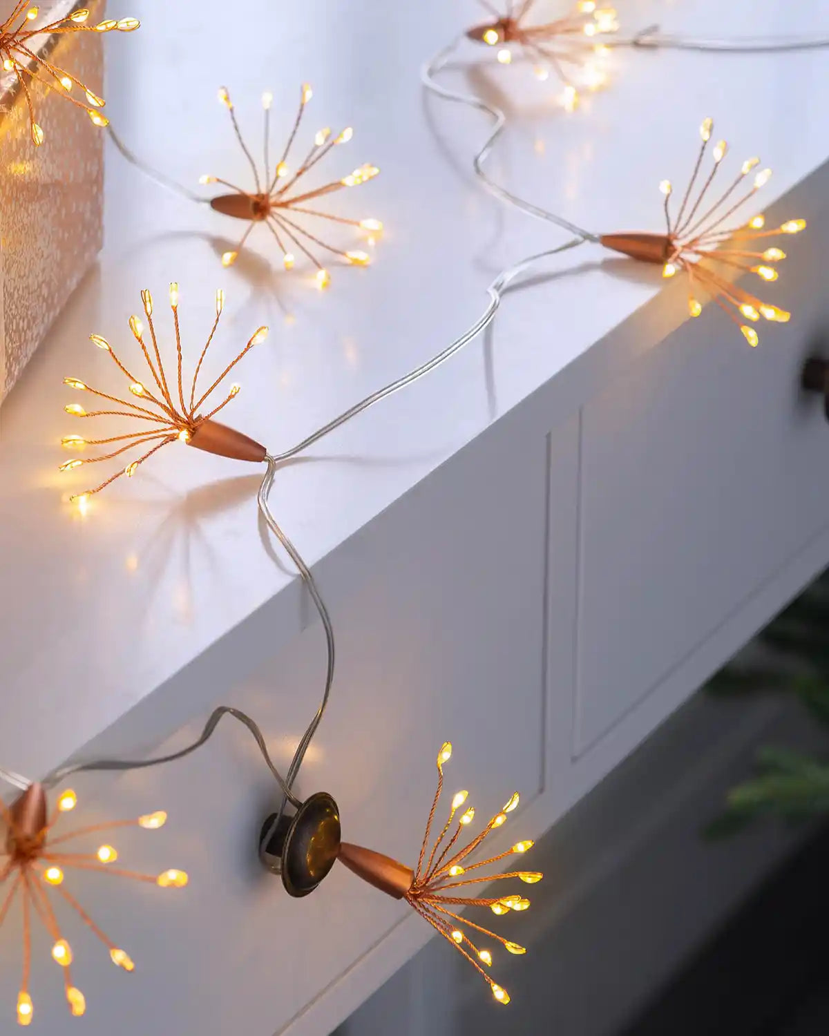 2 m copper wire firework string lights styled on a white surface with warm white LEDs