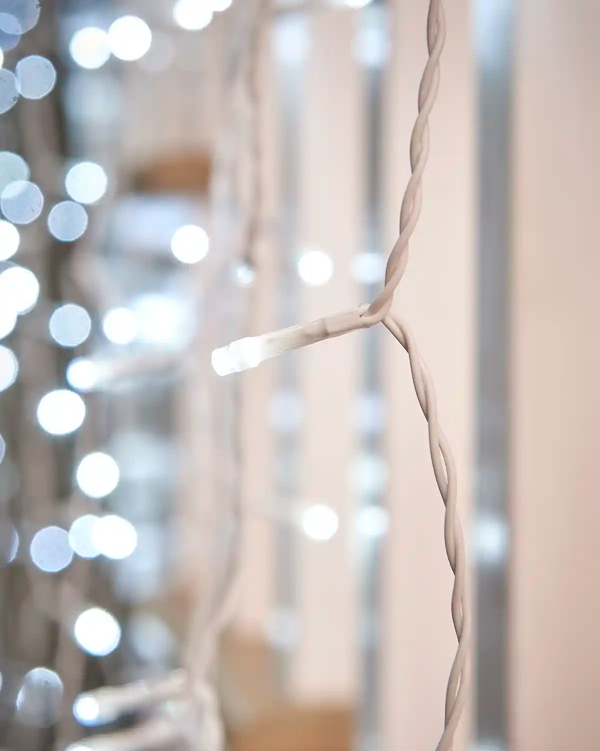 Close-up of a white LED on white cable.