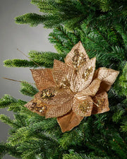 Gold artificial poinsettia flower styled in a Christmas tree