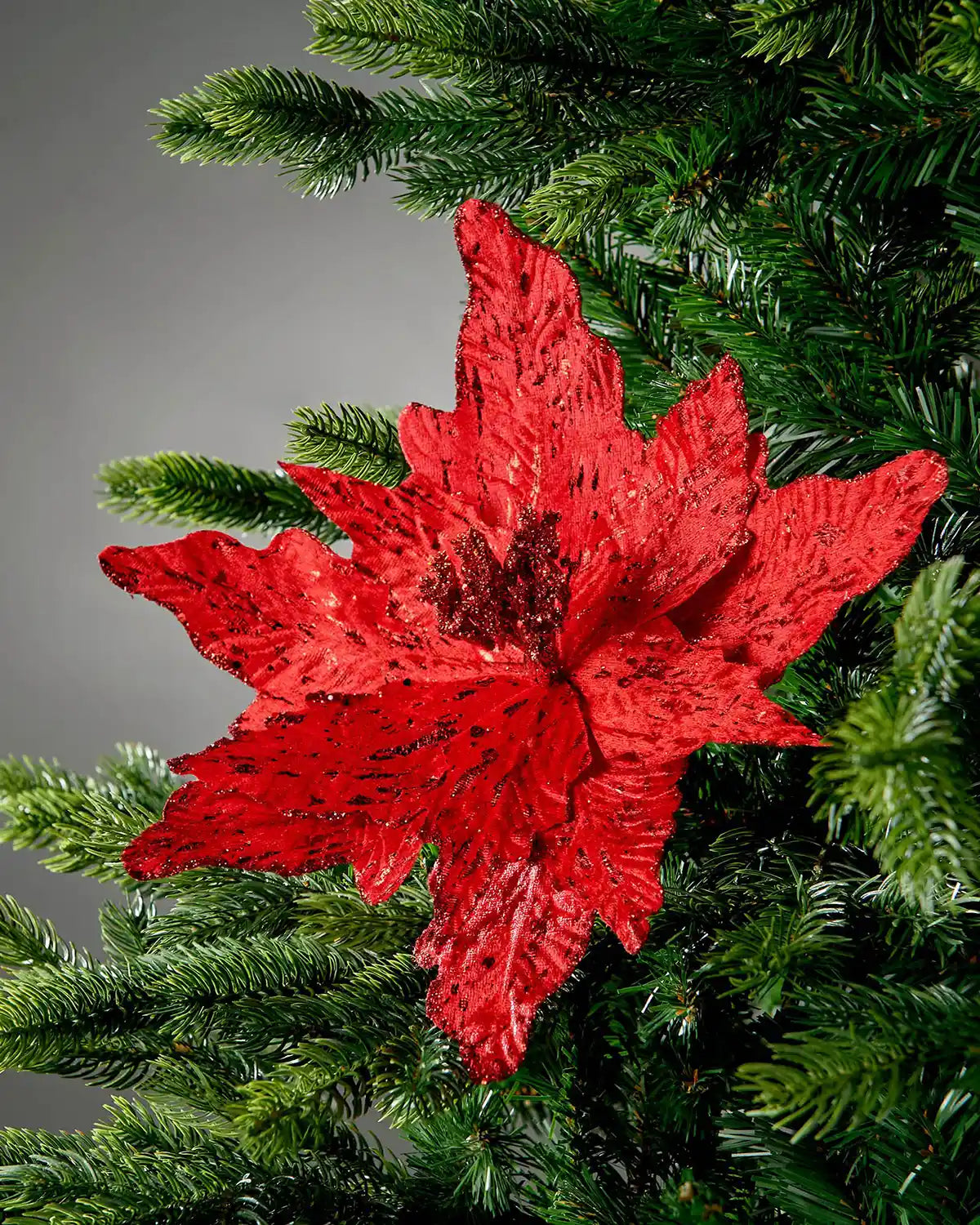 Red artificial poinsettia flower styled in a Christmas tree