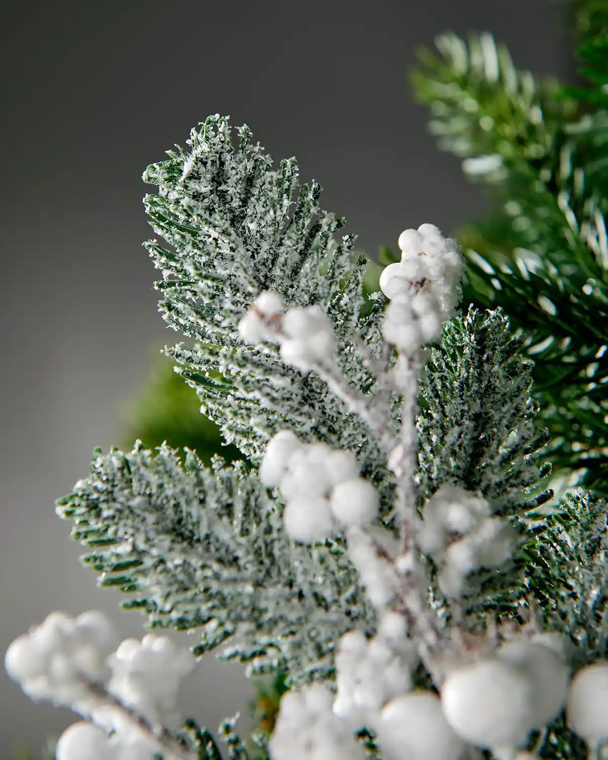 Close-up of the frosted pine sprigs and white berries on the 31 cm artificial pick