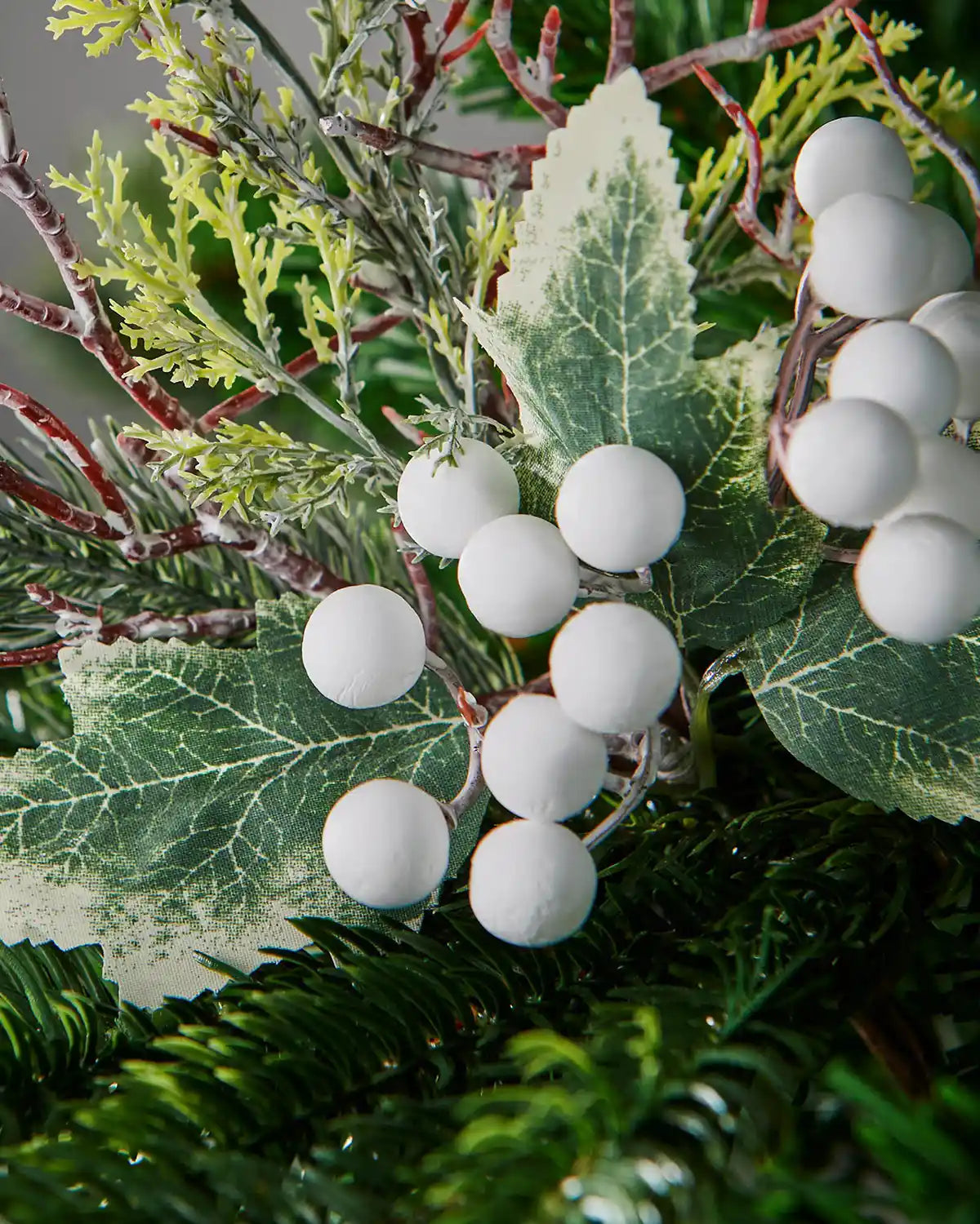 Close-up of white frosted berries and leaves on the 31 cm tree pick