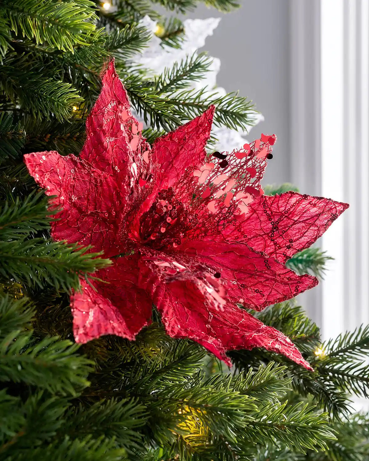 Red artificial poinsettia flower styled in a Christmas tree