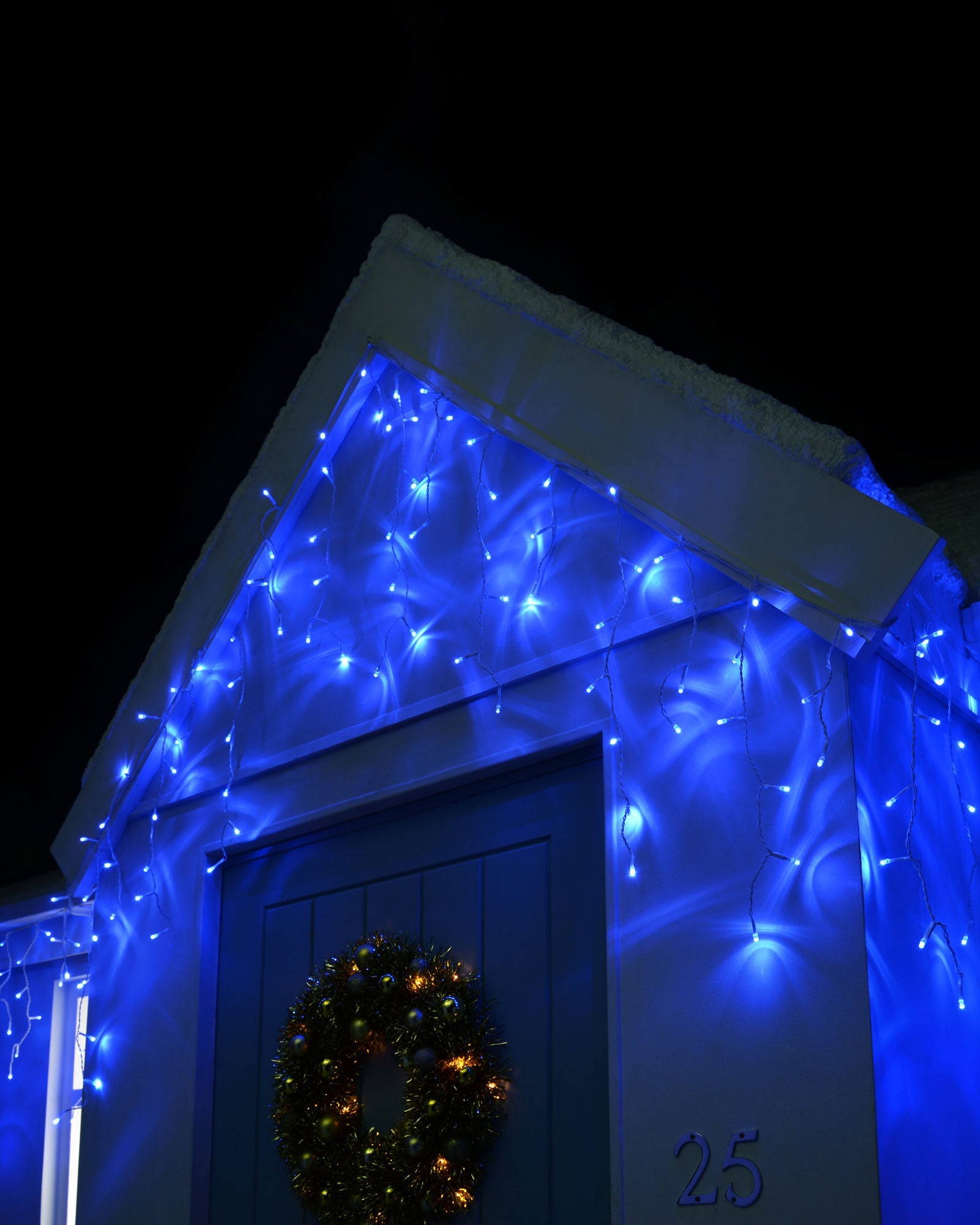 360 blue LED icicle lights displayed on the front of a house at night