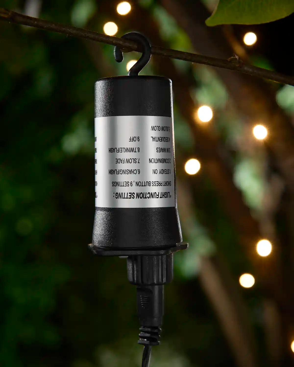 3AA Battery Box hanging from branch with warm white LEDs blurred in the background