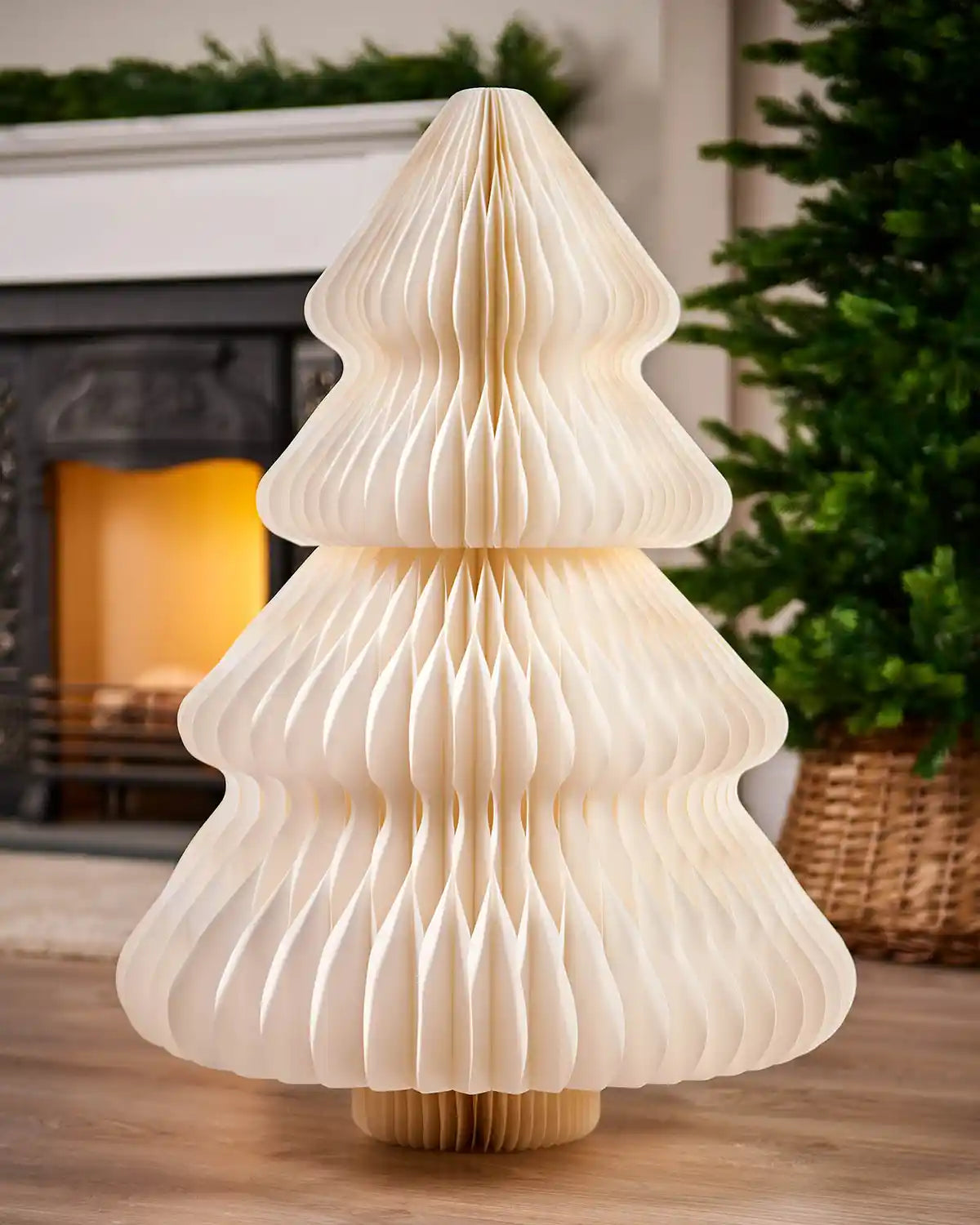 3ft off-white paper honeycomb Christmas tree displayed indoors beside a fireplace.