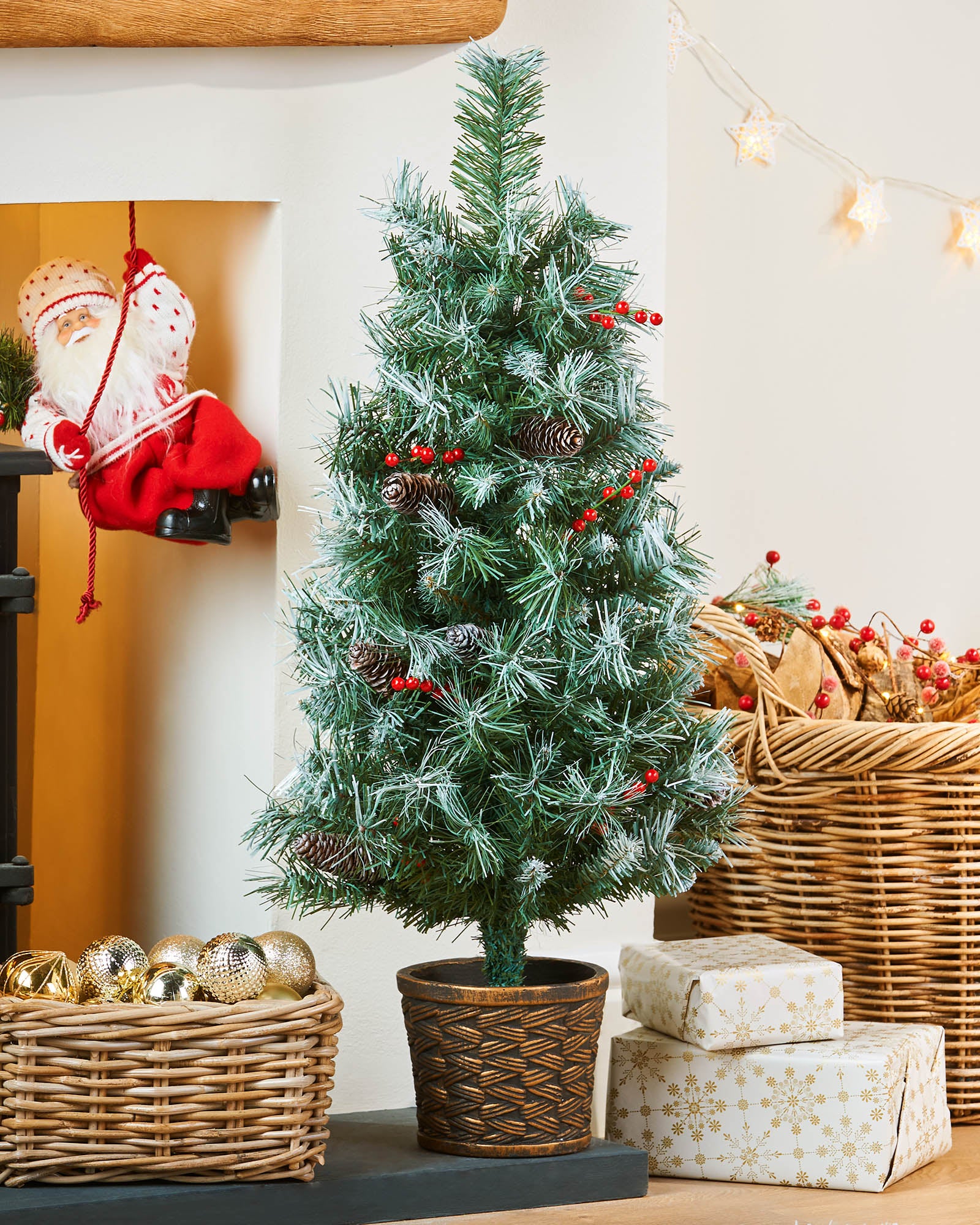3 ft potted Scandinavian blue spruce Christmas tree displayed by a fireplace with festive decorations