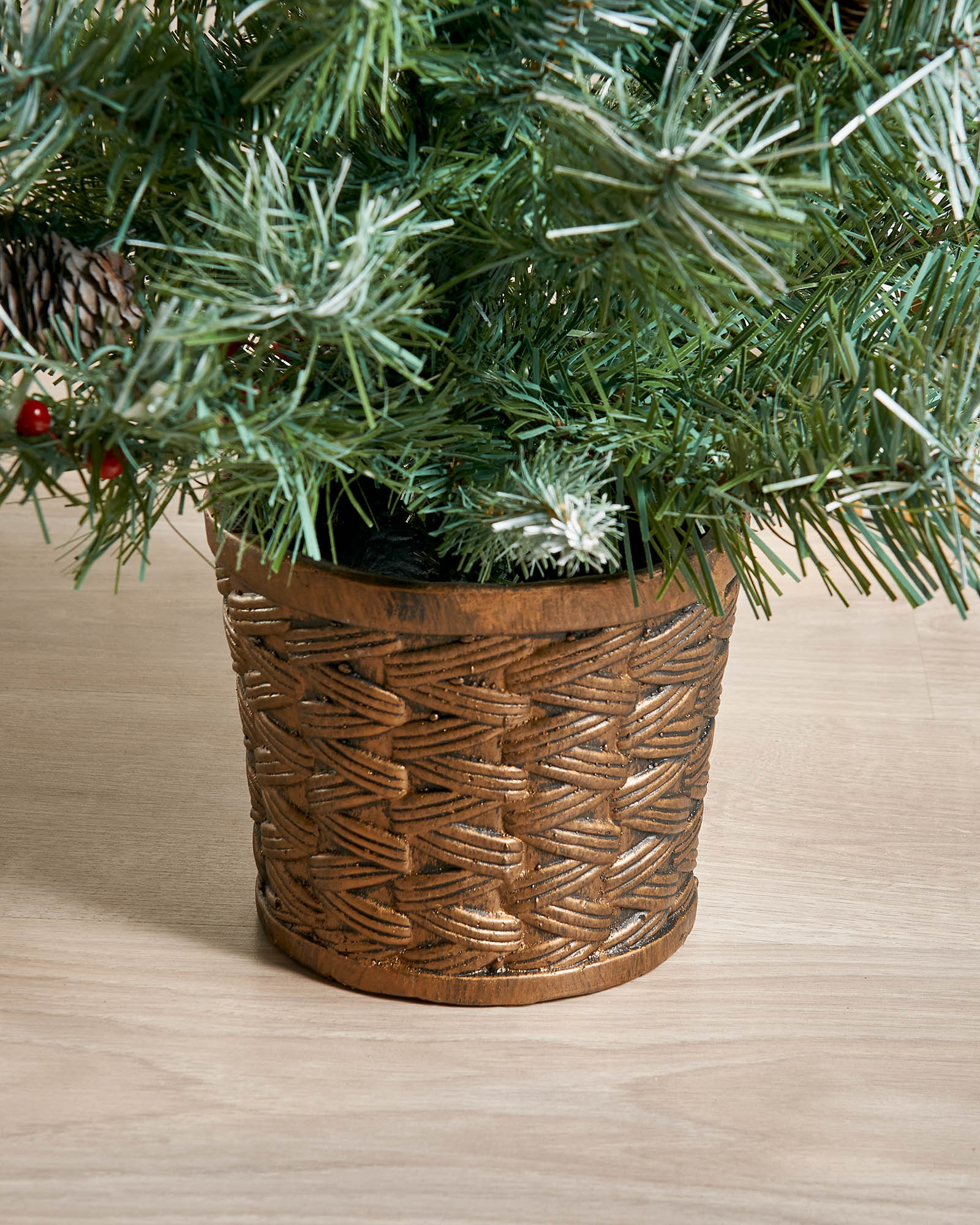 Close-up of the decorative gold resin pot on a 3 ft potted Scandinavian blue spruce Christmas tree