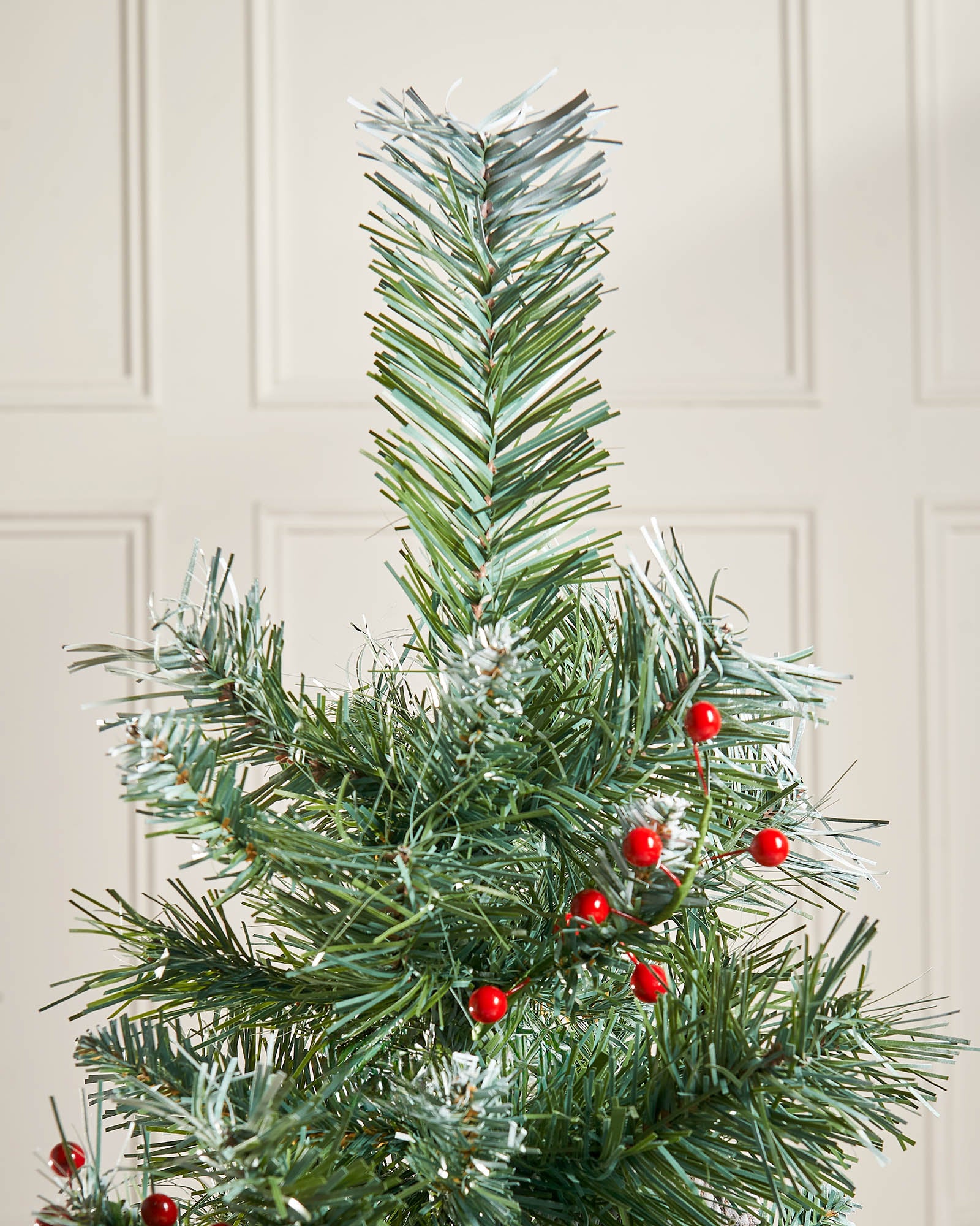 Top section of a 3 ft potted Scandinavian blue spruce Christmas tree with red berry detail