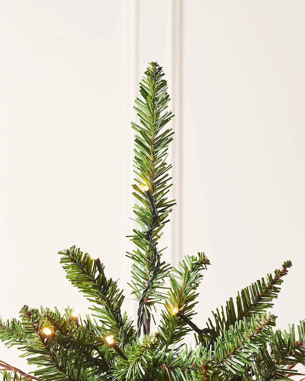Top section of a 4.5 ft pre-lit pines and berries potted Christmas tree with warm white lights