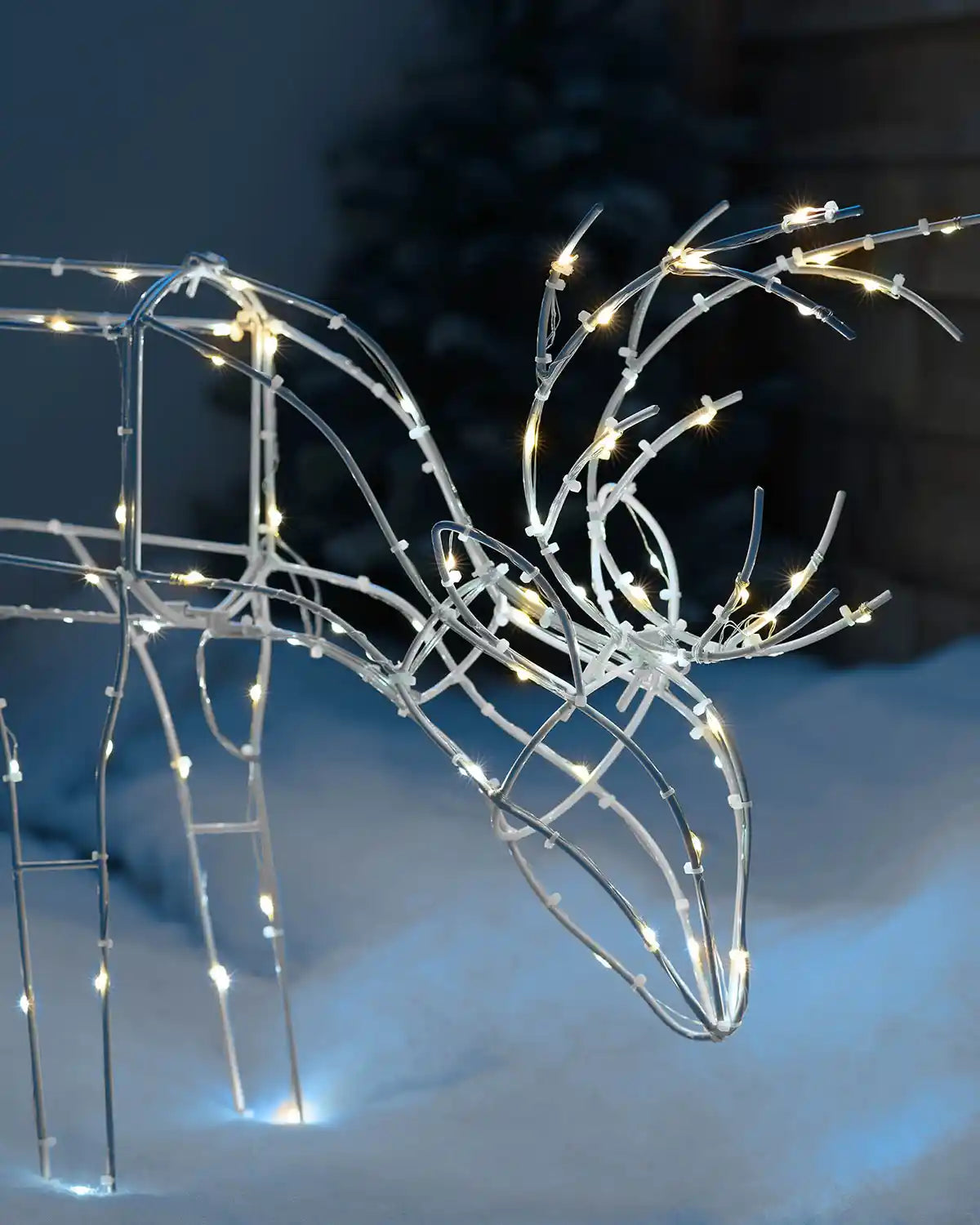 Close-up of the 40 cm pre-lit 3D grazing reindeer silhouette with illuminated antlers and frame