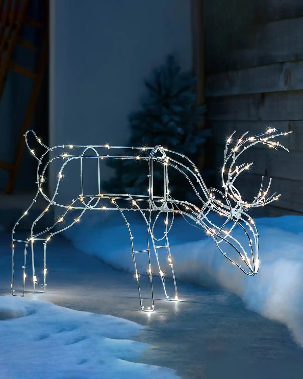 40 cm pre-lit 3D grazing reindeer silhouette displayed outdoors with warm white LEDs