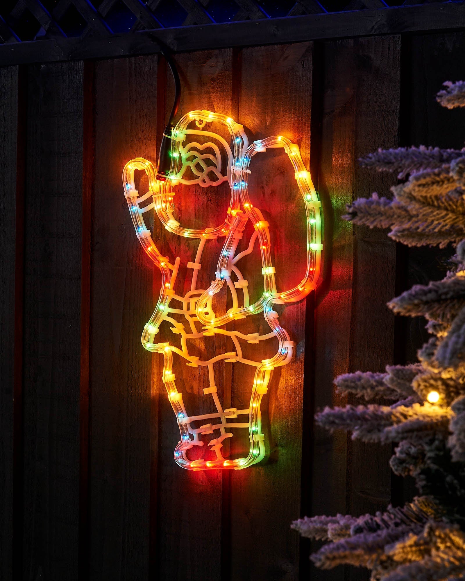 41 cm multi-coloured Santa with sack rope light displayed on a wooden fence