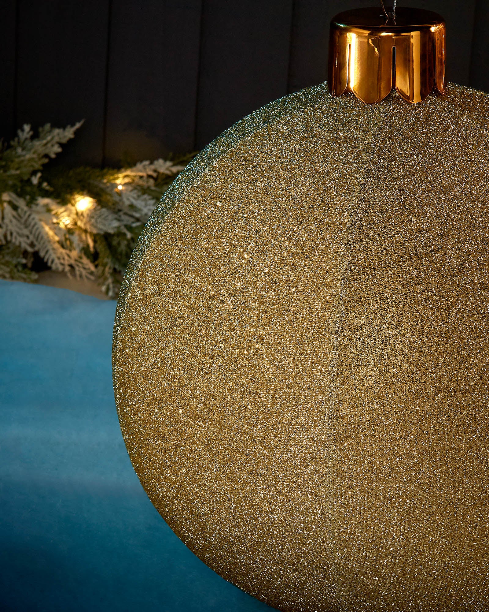 Detail close-up of the textured gold tinsel surface on a 45cm inflatable Christmas bauble.