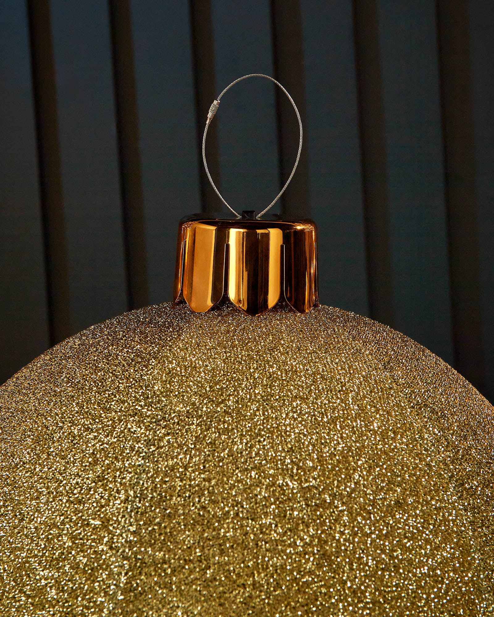 Close-up of the gold cap and hanging wire on a gold 45cm inflatable tinsel Christmas bauble.