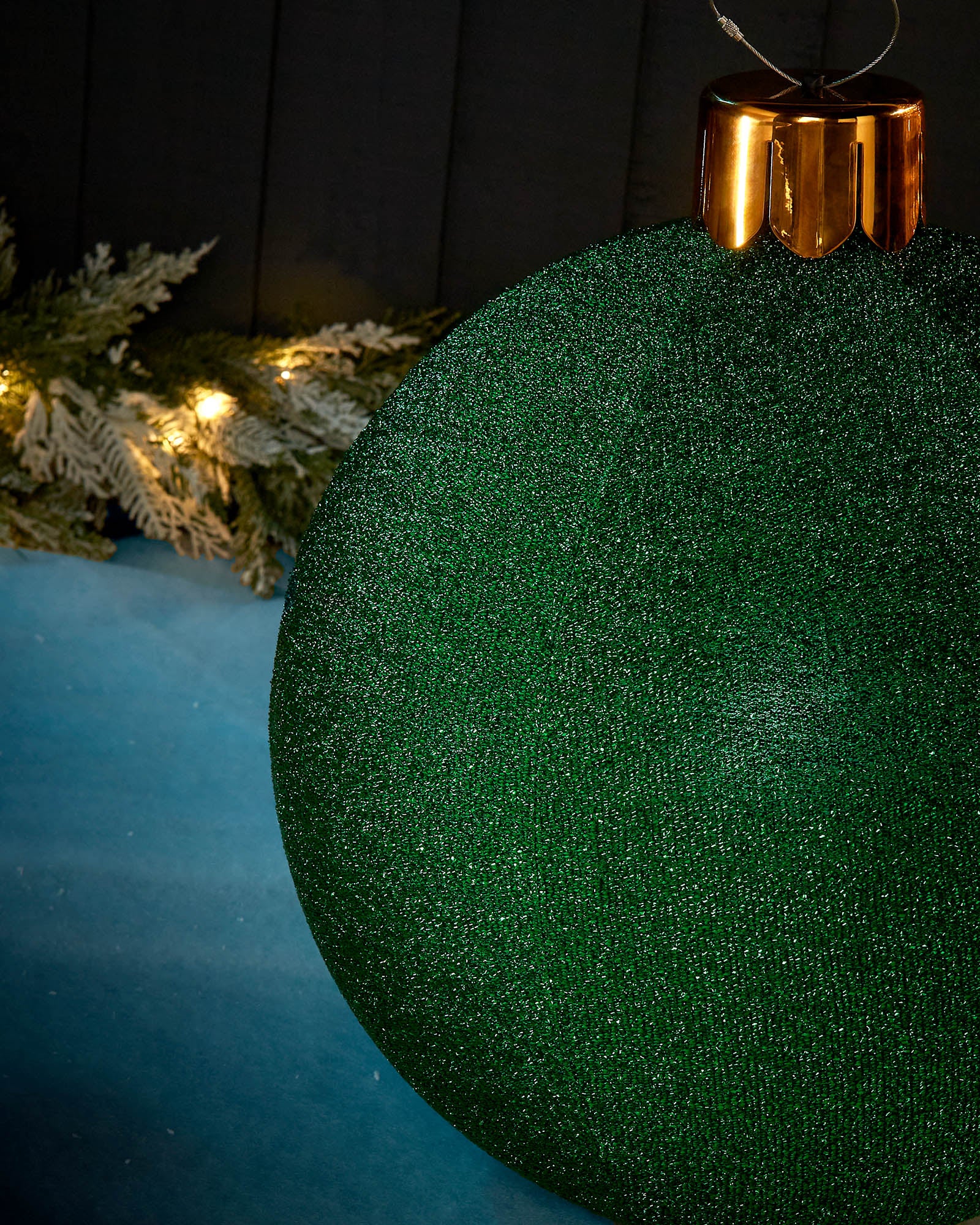 Detail close-up of the textured green tinsel surface on a 45cm inflatable Christmas bauble.
