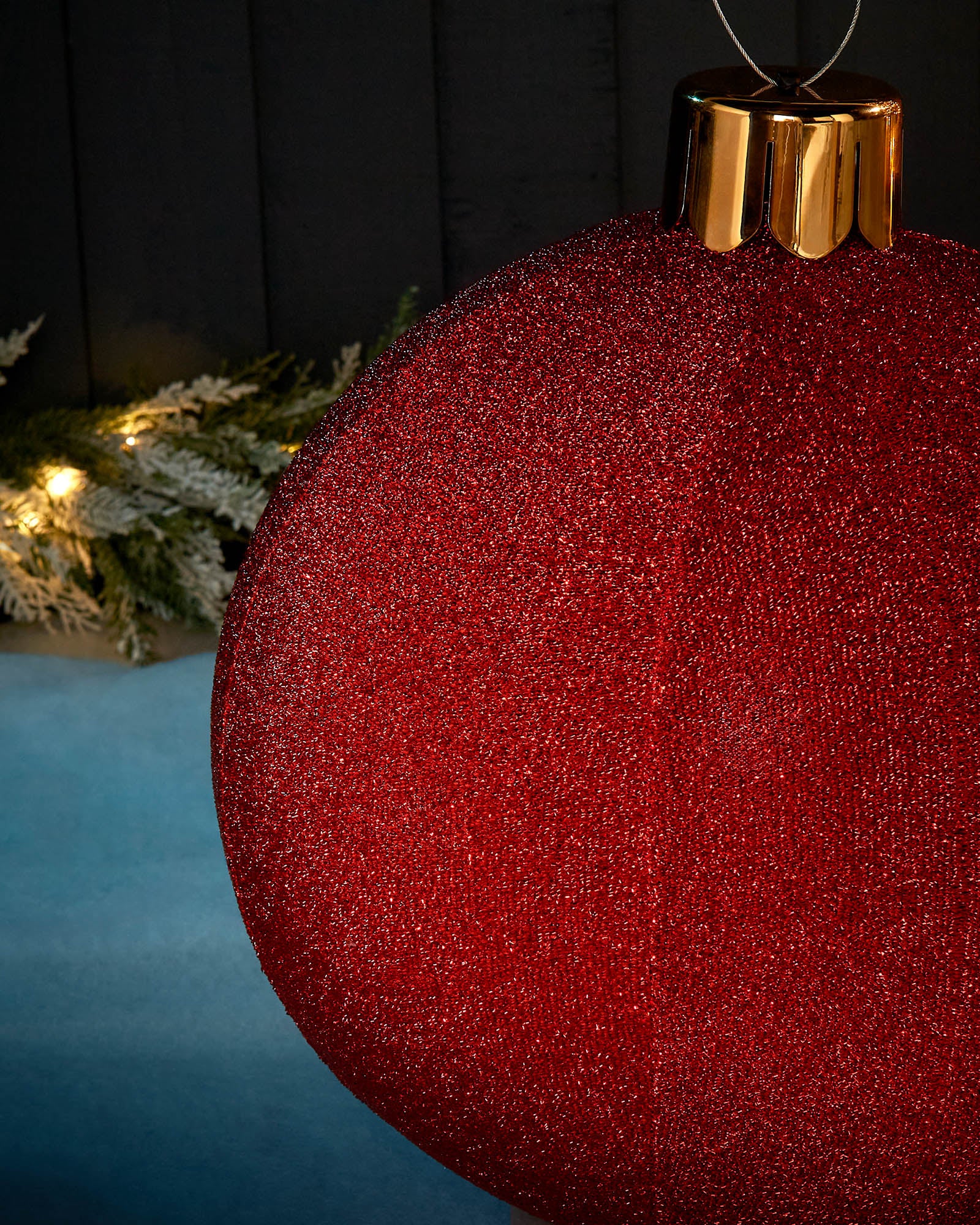 Detail close-up of the textured red tinsel surface on a 45cm inflatable Christmas bauble.