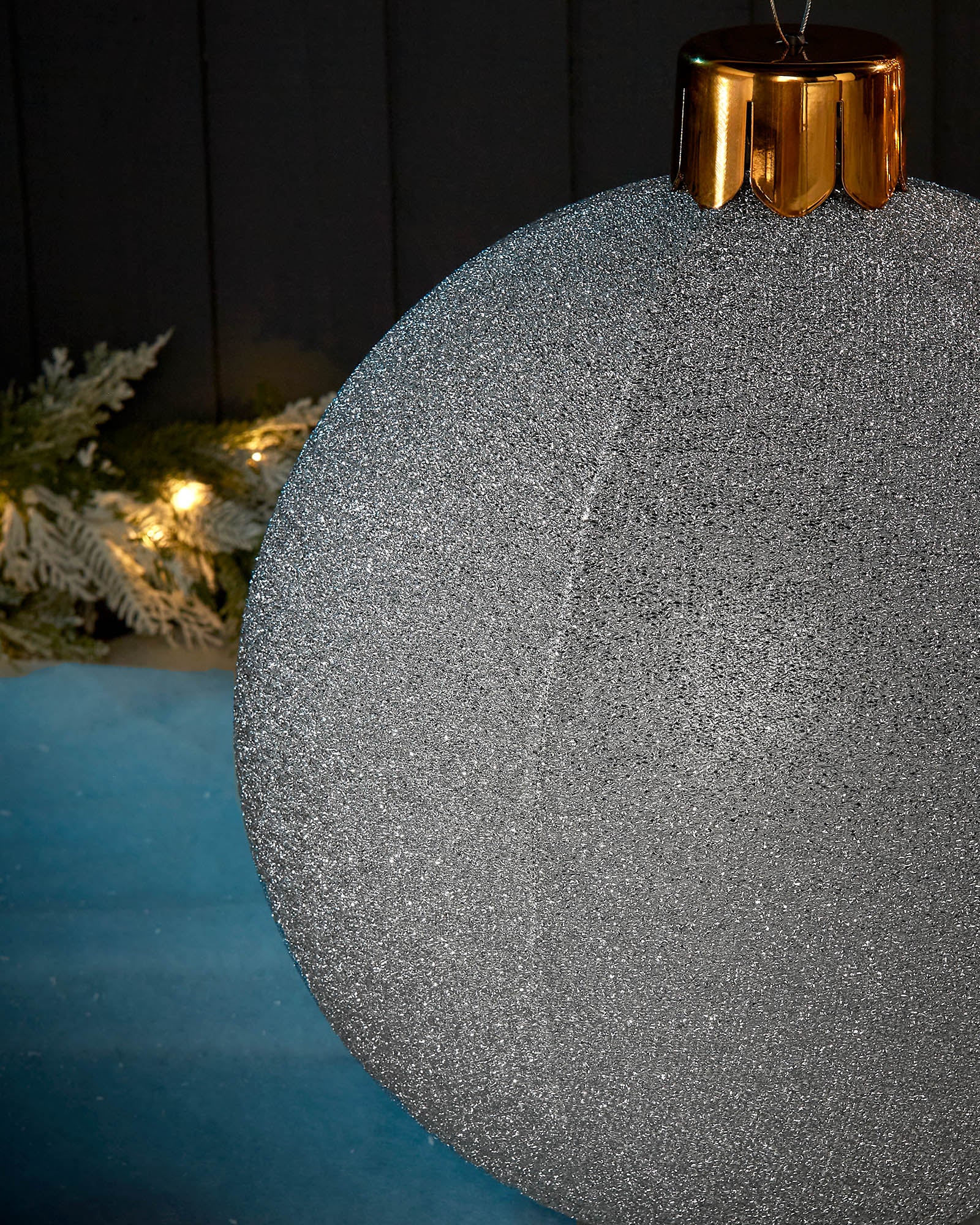 Detail close-up of the textured silver tinsel surface on a 45cm inflatable Christmas bauble.