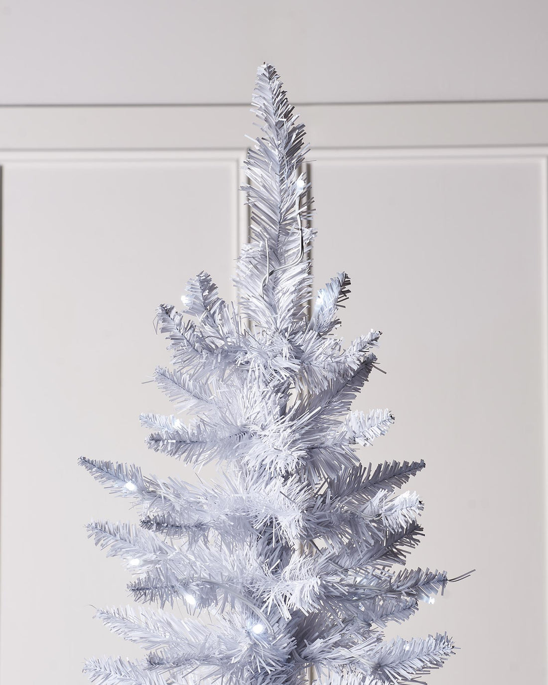 A pre-lit white pencil Christmas tree with slender branches, featuring 400 mixed PE and PVC tips and 180 bright white LED lights. The tree stands upright with a 64 cm diameter, blending modern elegance with festive charm.