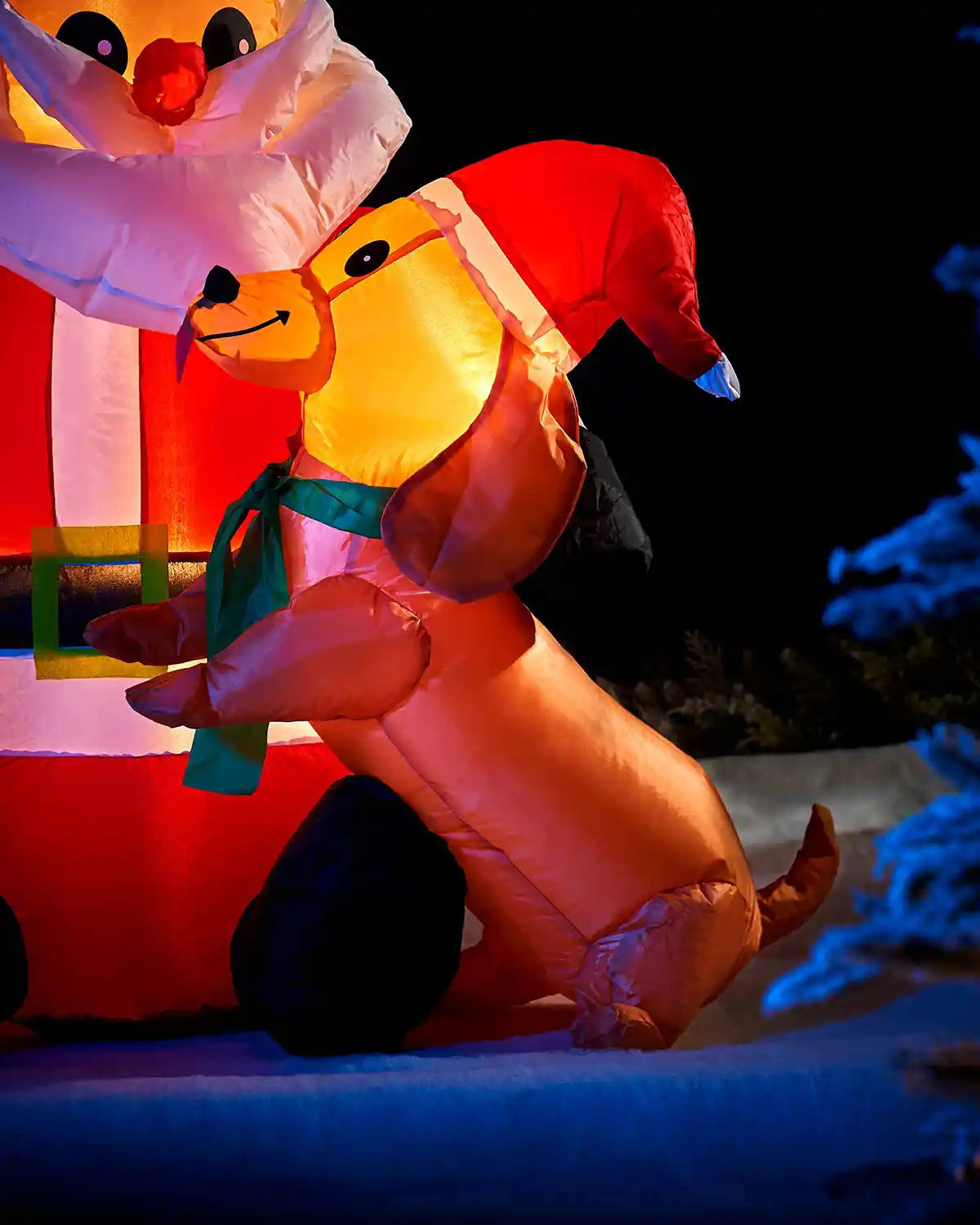 Close-up of the dog beside the 4 ft pre-lit inflatable Santa display