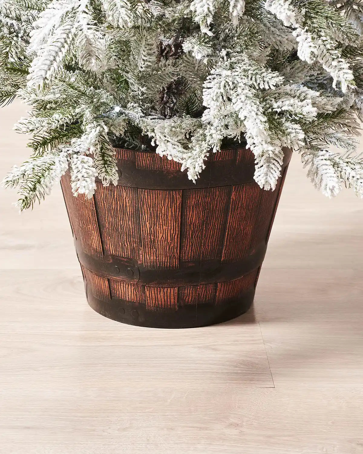 Close-up of the rustic decorative pot on a 4 ft pre-lit snow flocked Christmas tree