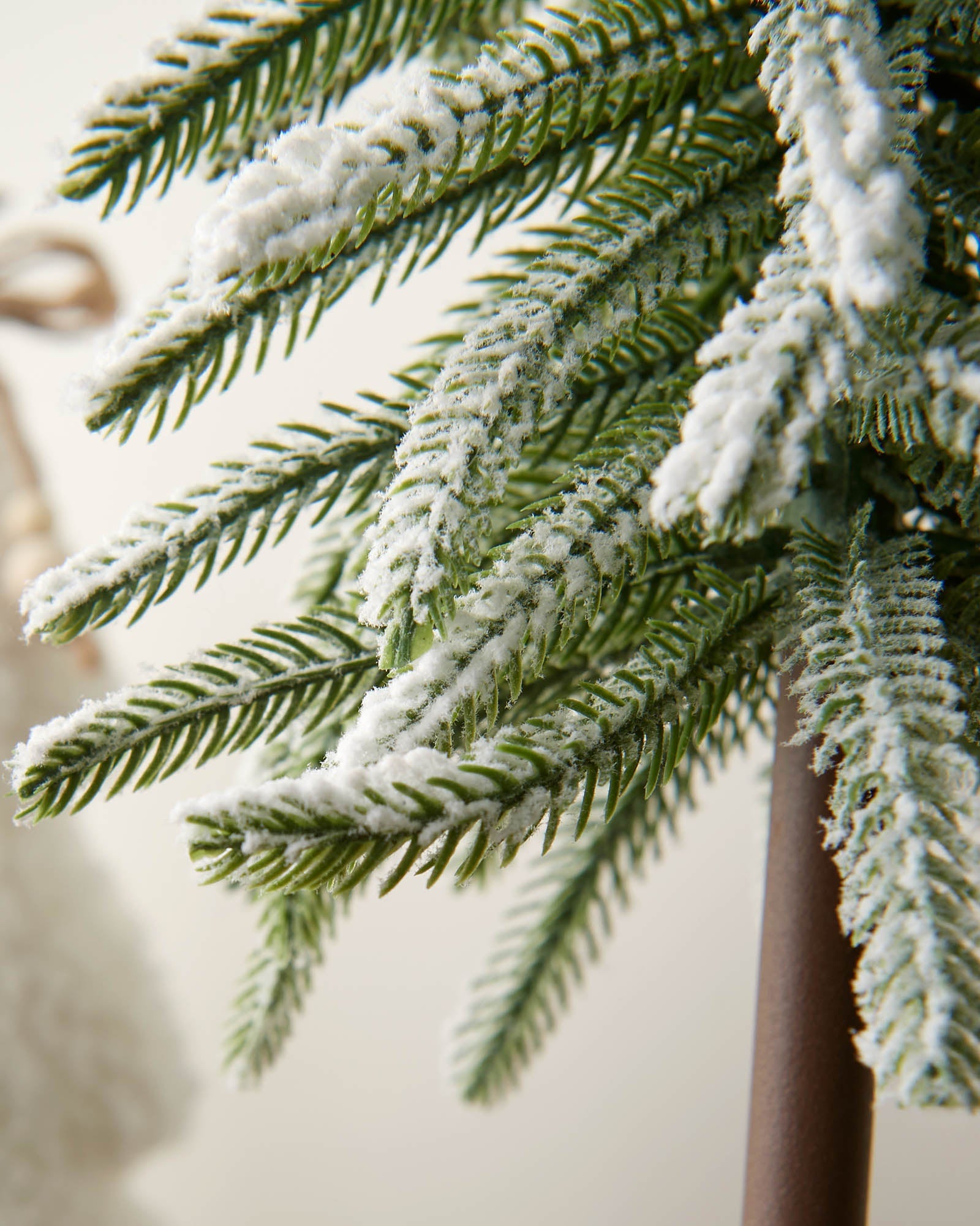 Close-up of snow-flocked fir branches on the 50cm tree trio decoration.