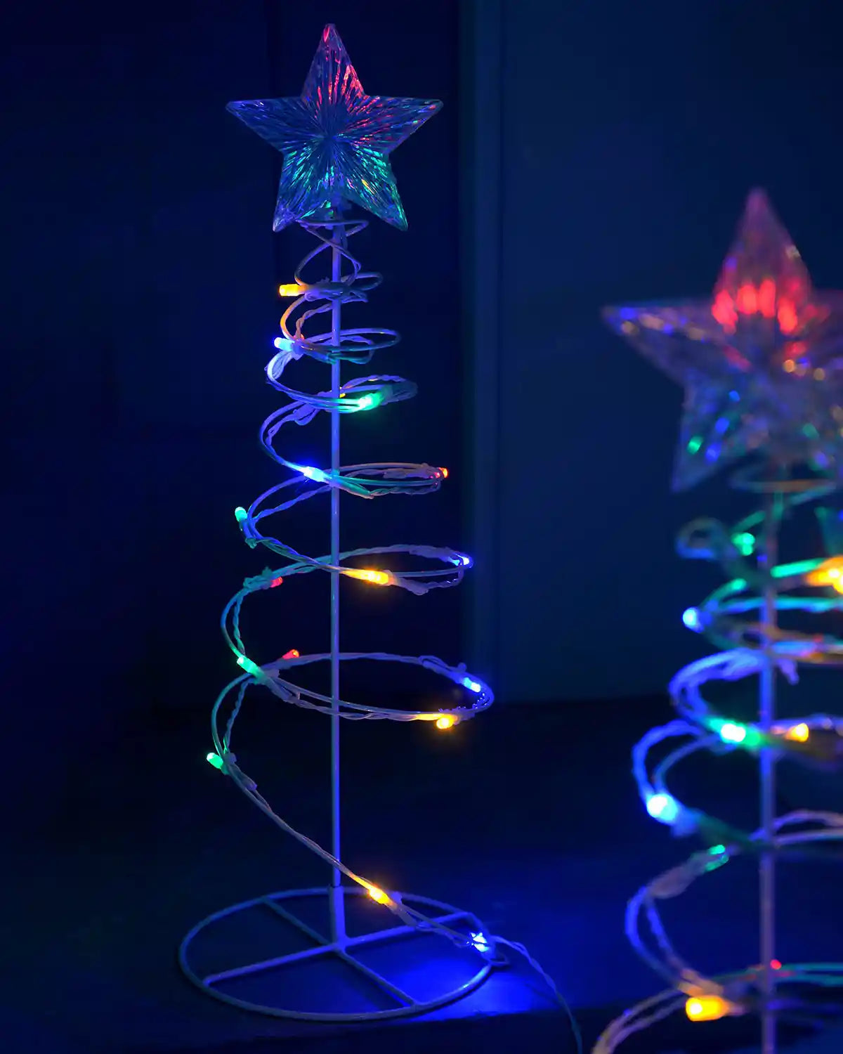 Close-up of a 55cm spiral tree light with multi-coloured LEDs and clear star topper