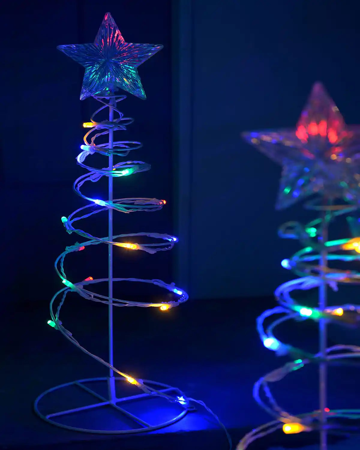 55cm pre-lit spiral tree light with multi-coloured LEDs shown indoors