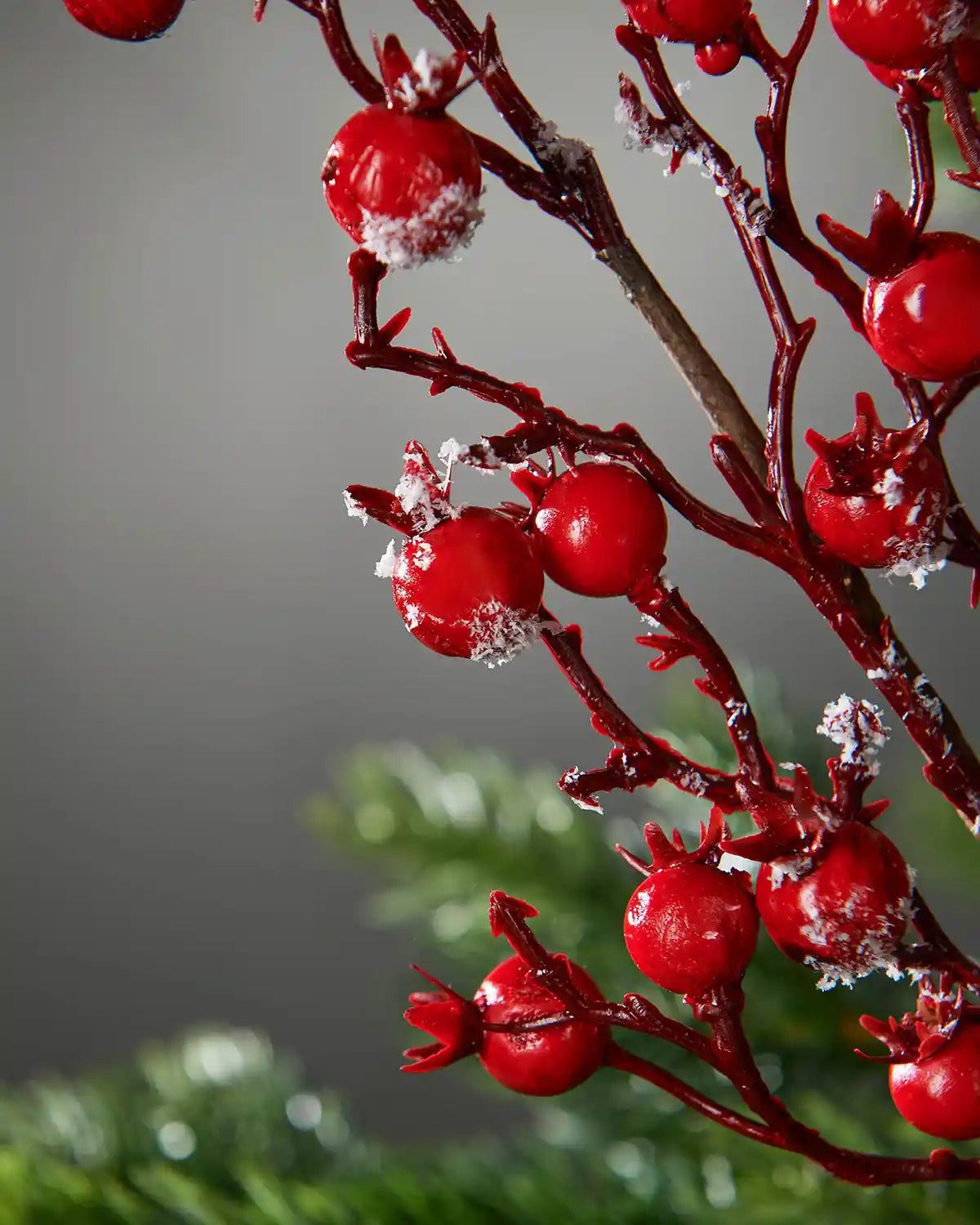 Close-up of the red berries and snow-dusted branches on the 57 cm artificial pick