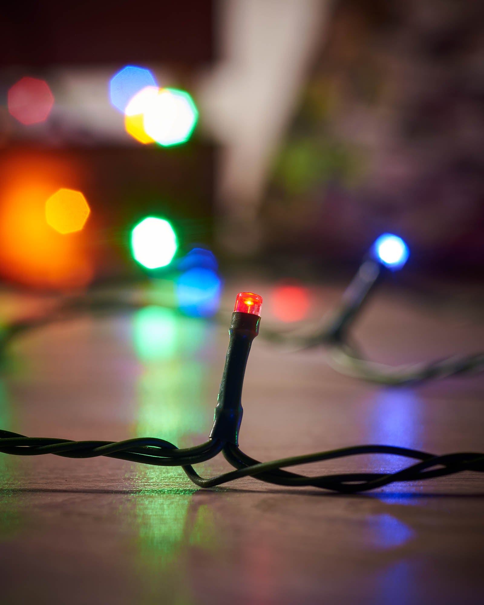 Close-up of Christmas lights with blurred colorful background