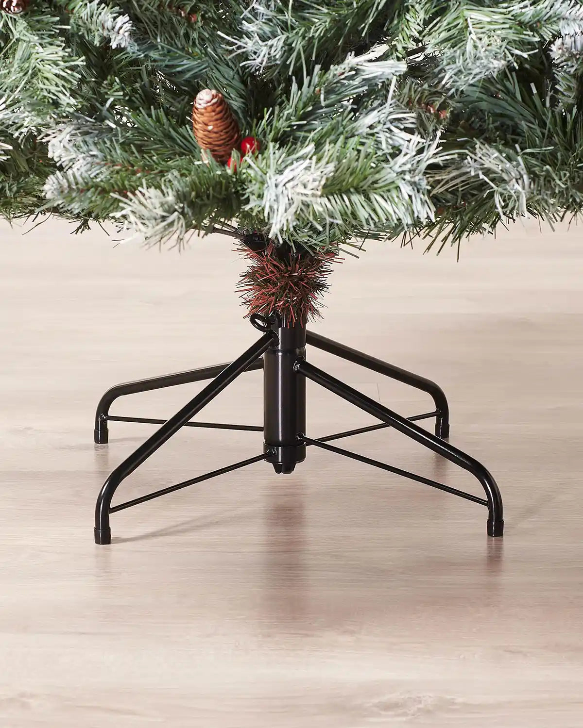 Close-up of the metal tree stand beneath a 5 ft Scandinavian blue spruce Christmas tree