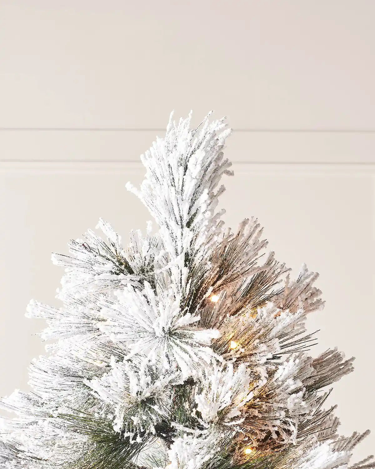 Close-up of the top branches on the 5 ft snow flocked pine needle Christmas tree