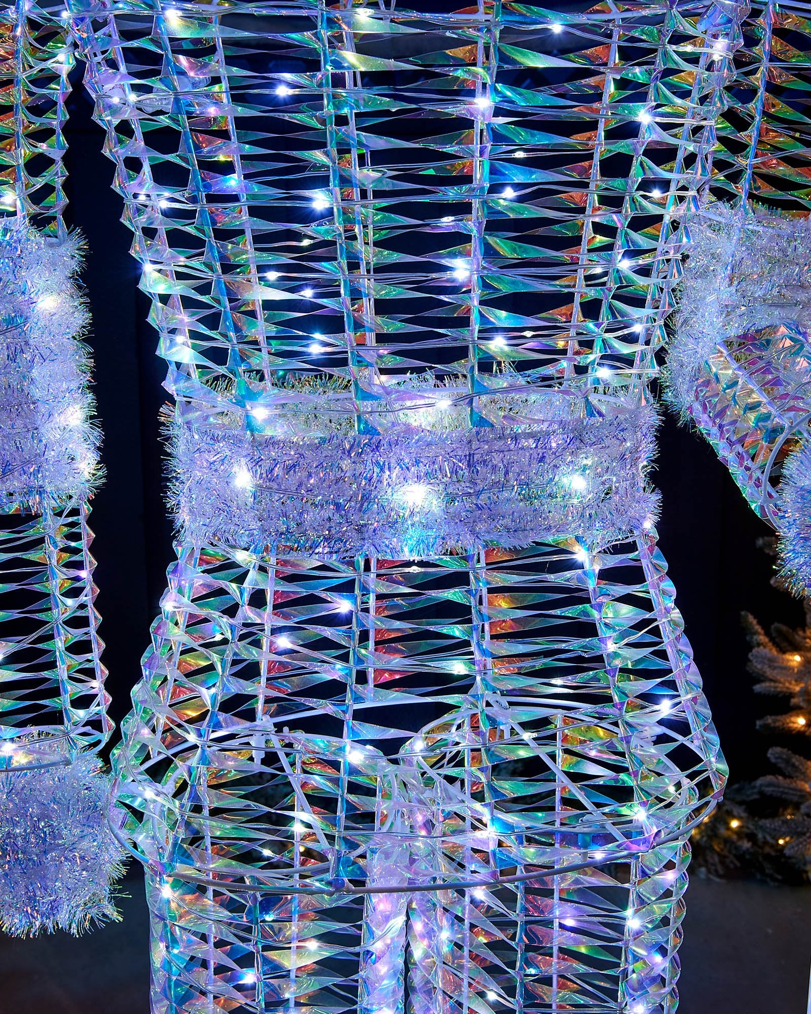 Close-up of the pre-lit iridescent Nutcracker body with tinsel belt and white LEDs.