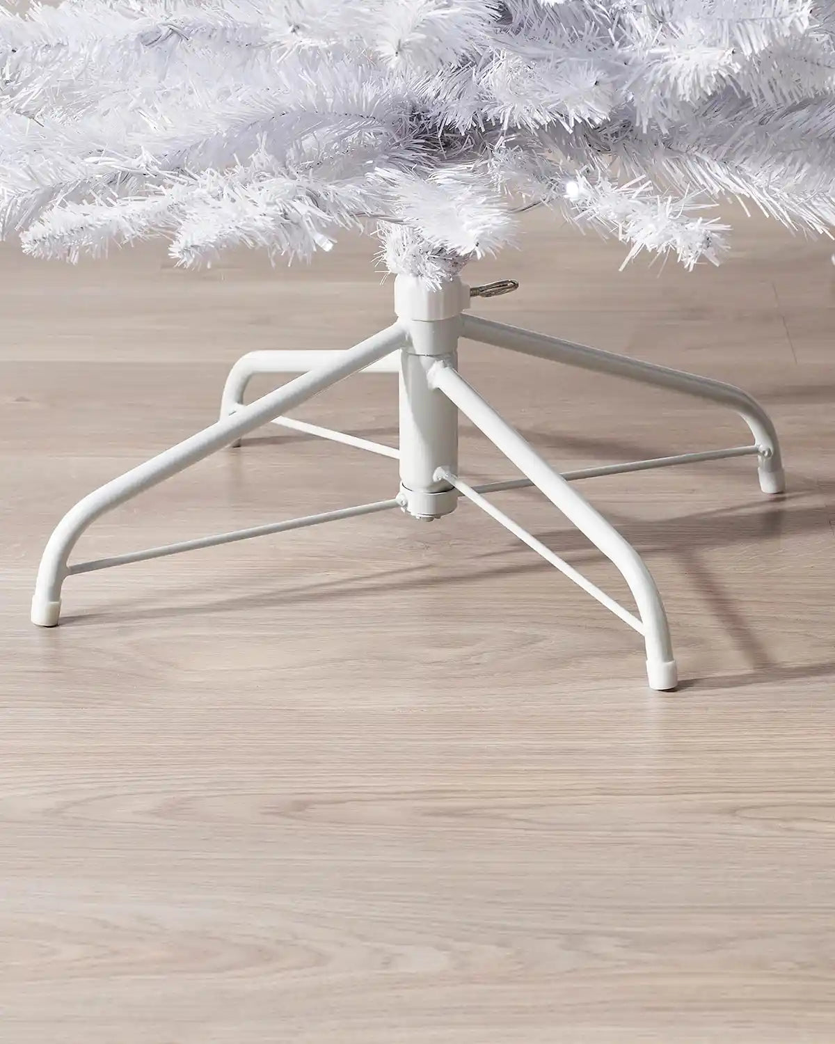 Close-up of the metal tree stand beneath a 6.5ft pre-lit white pencil Christmas tree