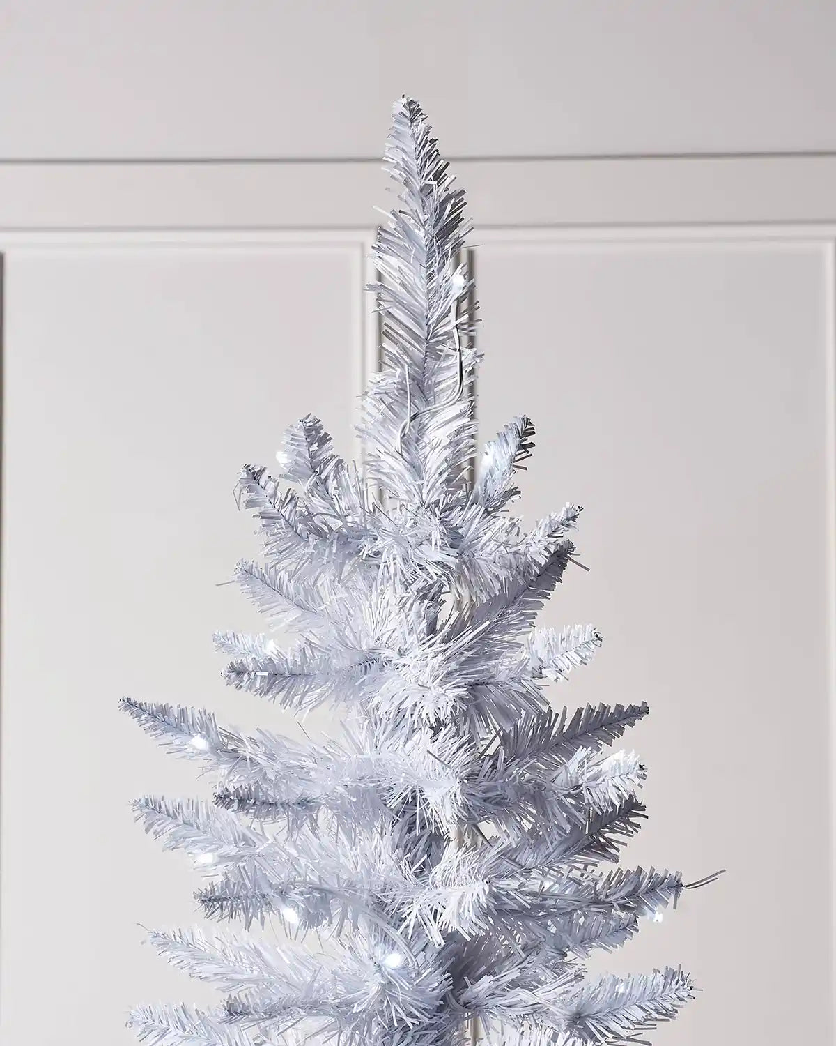 Top section of a 6.5ft white pencil Christmas tree with white lights