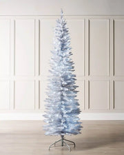 6.5ft white pencil Christmas tree displayed indoors with white LED lights and metal tree stand