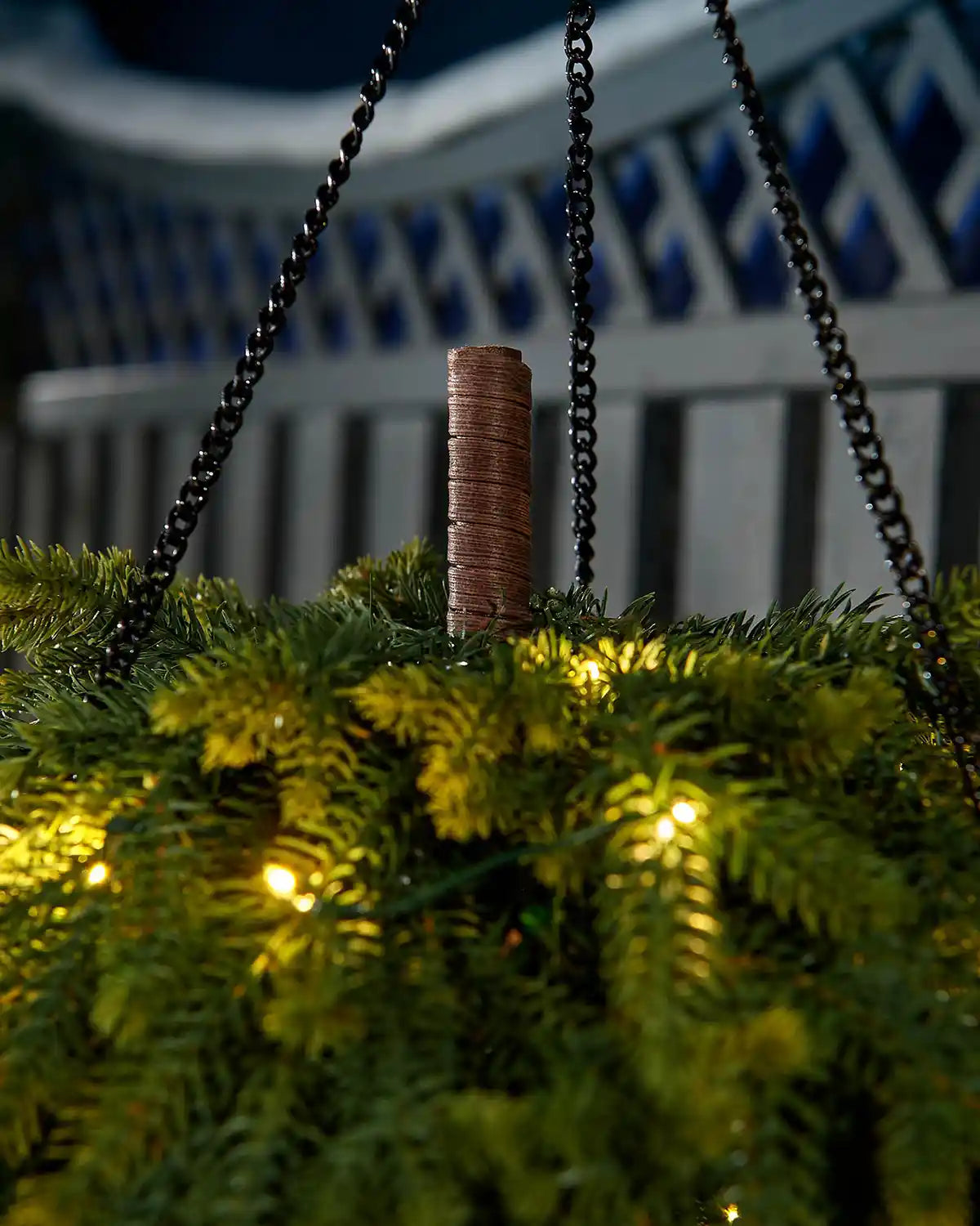 Detail of the black hanging chains and central stem on a pre-lit 3D teardrop swag.
