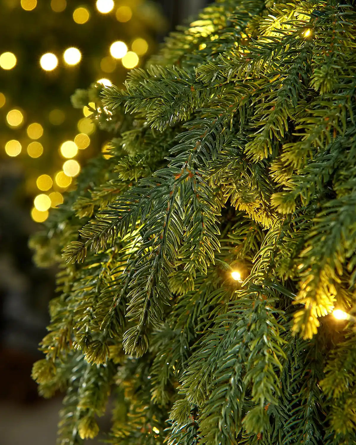 Close-up of the evergreen foliage on a 60cm pre-lit hanging teardrop swag with warm white LEDs.