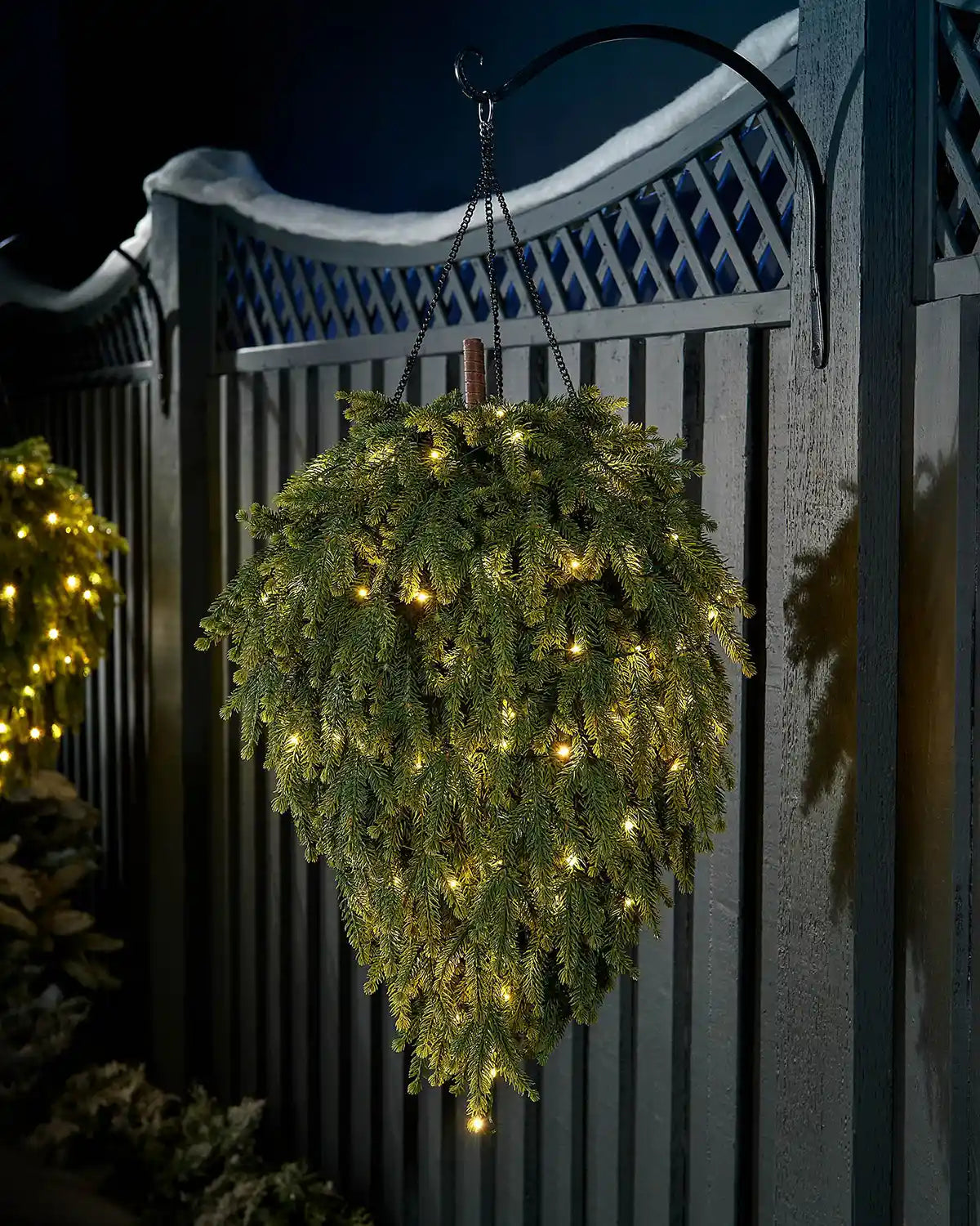 Pre-lit 60cm hanging teardrop swag with warm white LEDs displayed outdoors on a wall hook.