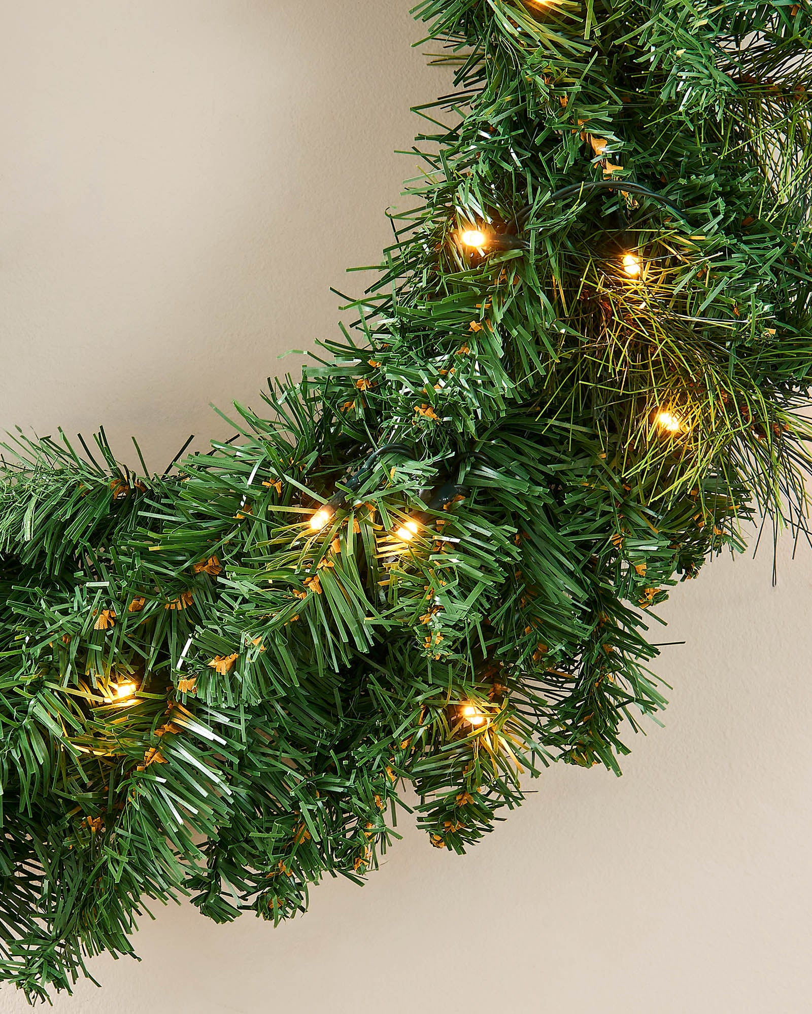 Warm white LEDs woven through a full green pre-lit Christmas wreath